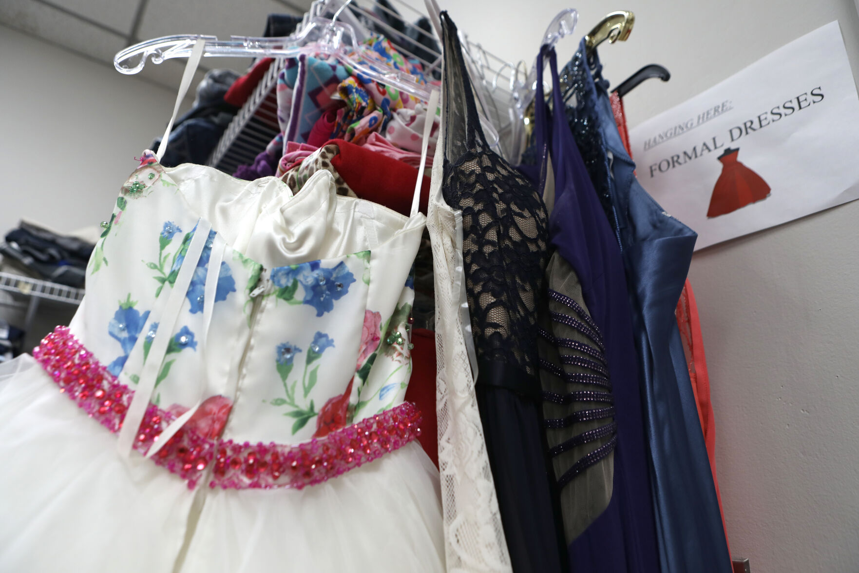 Prom dresses hang with other clothes